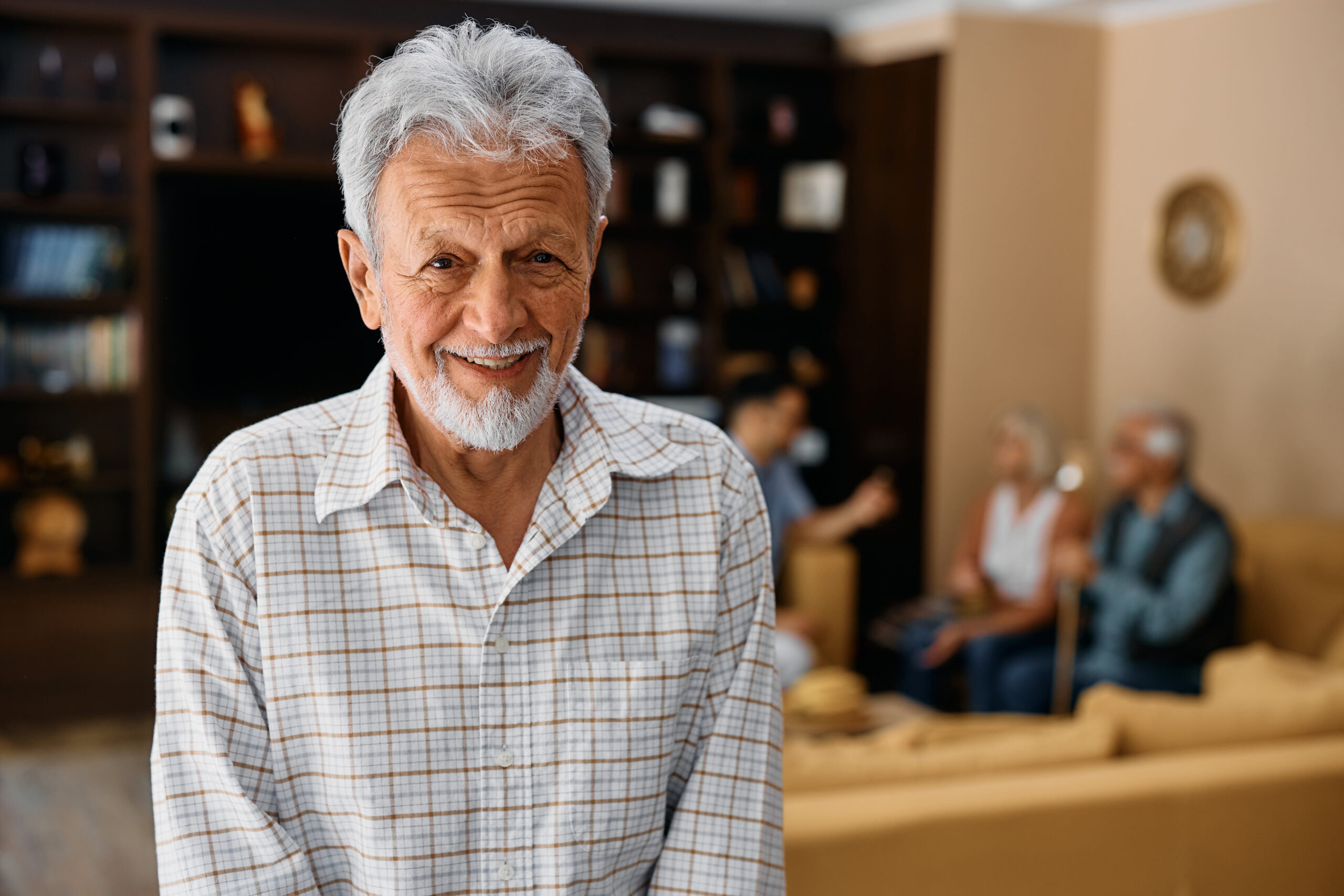 Portrait of happy elderly man at nursing home looking at camera.
